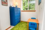 Kids cubby area in the bunkbed room with kids table. 